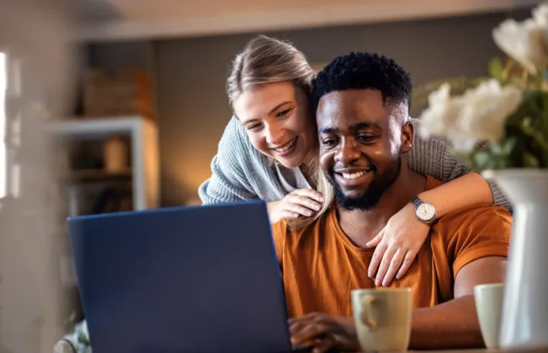 Couple reviewing top Utah Realtors on a laptop